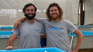 Sam Teicher and Gator Halpern stand at Coral Vita tank
